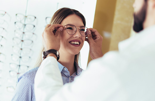 optician helping patient with glasses