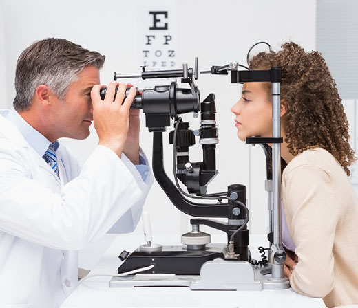 optometrist giving patient eye exam